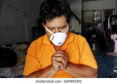 Asian Man Wearing A Sanitary Mask And Asks For A Blessing From God At Hom ,stay At Home 