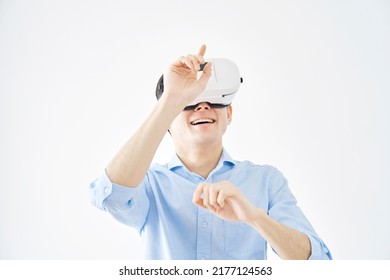 Asian Man Wearing VR Goggles In White Background