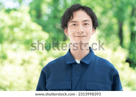 Asian man wearing work clothes