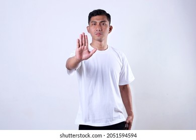 The Asian Man In White With A Stop Motion Expression Showed His Palm. Isolated On A White Background