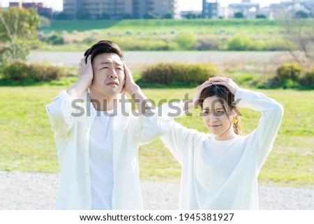 Asian man and woman worried