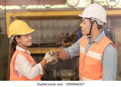 Asian Man And Women Workers Factory Working At Steel Heavy Machine. People Shaking Hands And Standing In Industrial Factory. Professional Engineering Training New Staff.