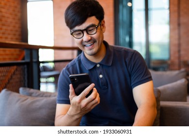 Asian Man Work Using Cell Phone Hand Holding Mobile Texting Message Contact Us.chatting,search Internet Information In Office.technology Device Communication Connecting