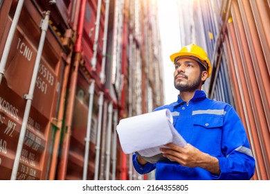Asian man worker using clipboard working in the container yard warehouse. Container yard warehouse inspection. Cargo Shipping Import and Export industry. Logistic shipping yard business.
