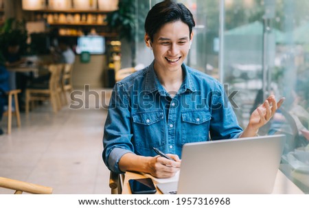 Asian man working at cafe on weekend
