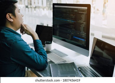 Asian man working code program developer computer web development working design software on desk in office.