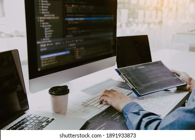 Asian Man Working Code Program Developer Computer Web Development Working Design Software On Desk In Office.