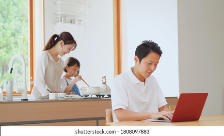 Asian man working at home with the PC - Powered by Shutterstock