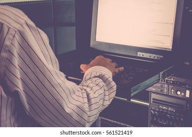 Asian Man Working On His Computer Server Mainframe In A Data Center , Process In Vintage Style