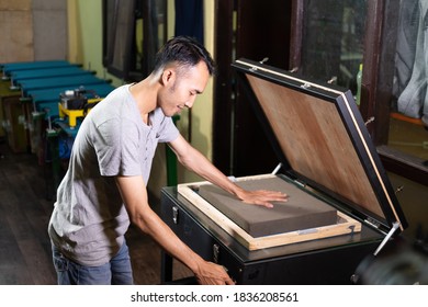 Asian Man Working Pressing A Sponge To Make Film On Silk Screen Surface