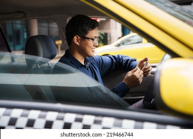 Asian man working as taxi driver in yellow car, with female client paying cash and leaving