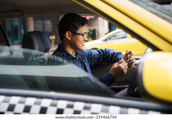 Asian man working as taxi driver in\
yellow car, with female client paying cash and\
leaving