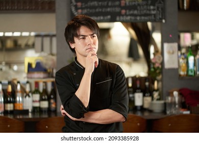 Asian Man Worried At A Restaurant