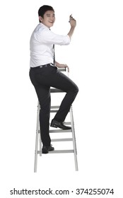 Asian Man Write Something With Pen On The Ladder Isolated Over White Background