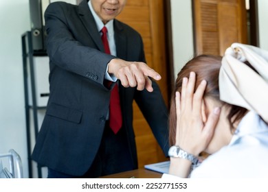 asian manager boss angry pointing at employees who are not working according to orders or are late in the office - Shutterstock ID 2252771553