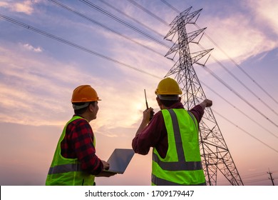 Asian Manager Engineering and worker in standard safety uniform working inspect the electricity high voltage pole. - Shutterstock ID 1709179447