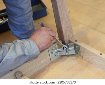 Asian Man's Hand Assembling Furniture