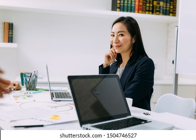 Asian Mature Business Woman Smiling And Looking At Camera While Sitting In Meeting. Smart Middle Age Lady Portrait