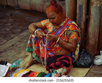 An Asian Mature Lady Sitting At Street Shop For Selling Fashionable Product At Varanasi Uttar Pradesh In India Shot Captured On March 2022.