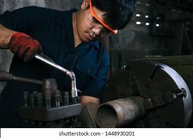 Asian Mechanical Engineer Operating Industrial Lathe Machine - Millennial Internship Boy Training On Manufacturing Fabrication Equipment - Diverse Skilled Hispanic Immigrant Factory Worker In Workshop