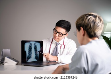 Asian medical doctor orthopaedic surgeon wearing stethoscope showing x-ray image from laptop while explaining and soothing patient about diagnosis and treatment plan in examination room in hospital.  - Powered by Shutterstock