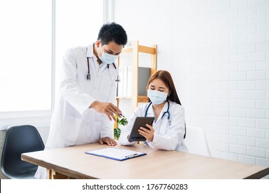 Asian Medical Healthcare Doctor Colleague Teamwork Working Together Examine Diagnosing Discussing Using Tablet Wearing Surgical Mask Work At Home Modern Office Wireless Online Technology Communication