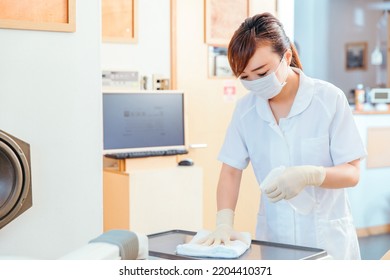 Asian medical staff disinfecting (dentist) - Powered by Shutterstock