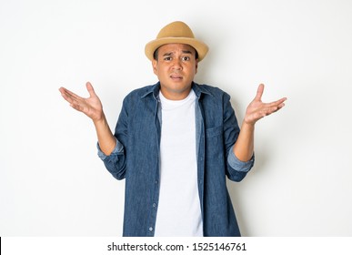 Asian men around the age of 27-35 are thinking and making faces, confused, not understanding, wondering with something. This photo was taken in the studio. With a white background.