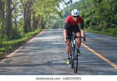 Asian Men Are Cycling Road Bike In The Morning