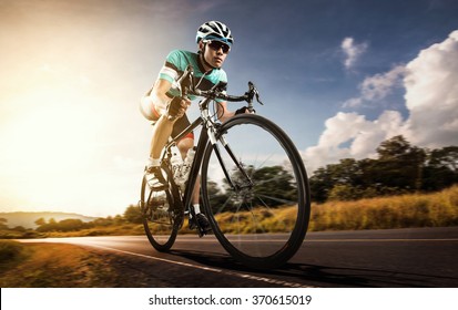 Asian men are cycling road bike in the morning - Shutterstock ID 370615019