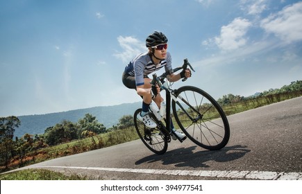 Asian Men Are Cycling Road Bike In The Morning