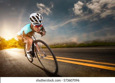 Asian Men Are Cycling Road Bike In The Morning.downhill