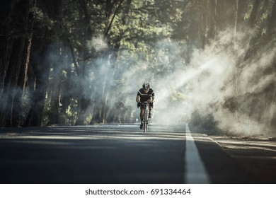 Asian Men Are Cycling Road Bike In The Morning