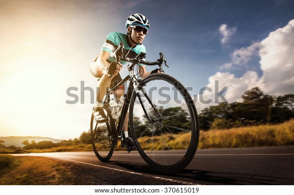 Asian men are\
cycling road bike in the\
morning