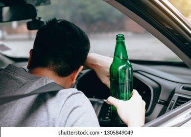 Asian Men Drink A Lot Of Alcohol Until And Unconscious His Can't Drive Home And Decide To Sleep At The Steering Wheel.