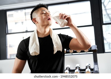 Asian Men Drinking Protein After Training