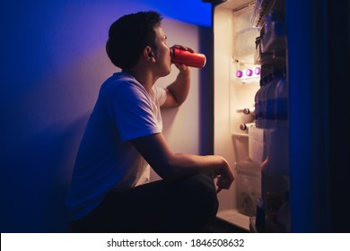  Asian Men He Is Opening The Refrigerator.Drink Soft Drinks At Night