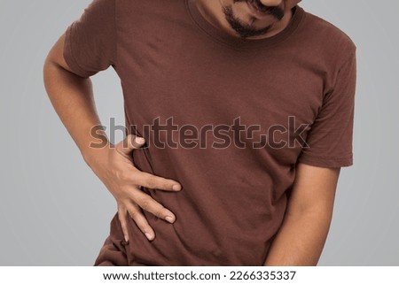 Asian men ribcage pain on gray background.