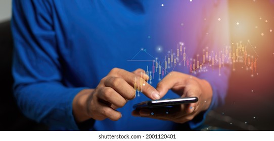 Asian Men Wearing Blue Shirts Trade Stocks At Home Using Mobile Phones As A Connection To People All Over The World Online, Name Sales In The System.