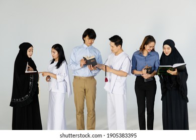 Asian men and women of different religions have Buddhism,Muslims, Christ. bible Quran. A smiling face wearing religious clothes, white background. Concept religions exchange teachings with one another - Shutterstock ID 1905383395