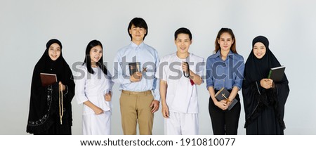 Asian men and women of different religions have Buddhism, Muslims, Christ bible Quran. A smiling face wearing religious clothes, white background. Concept religions exchange teachings with one another