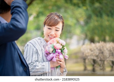 Asian Men And Women Who Propose With A Bouquet