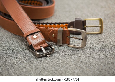 Asian men's vintage belt stylish, placed on a carpeted gray carpet on the floor.