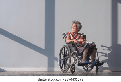 Asian Mental Healthy Elderly Woman on Wheelchair relaxing in Resting area while waiting for her annual Medical Checkup inside of Hospital. Health care and Good mental Health concept - Powered by Shutterstock