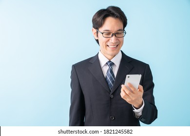 Asian Middle Age Businessman Who Uses Smart Phone