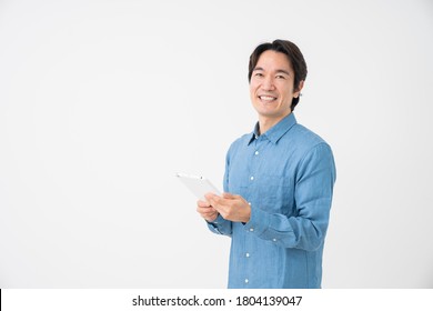 Asian Middle Age Man Who Uses Tablet Computer