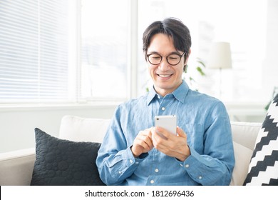 Asian Middle Age Man Who Uses Smart Phone