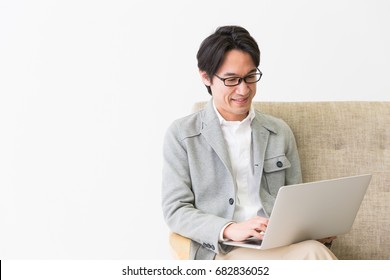 Asian Middle Age Man Who Uses Laptop