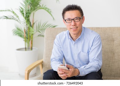 Asian Middle Age Man Who Uses Smart Phone