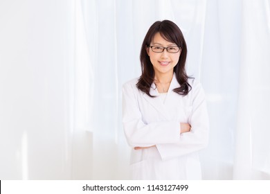 Asian Middle Age Woman In A White Coat